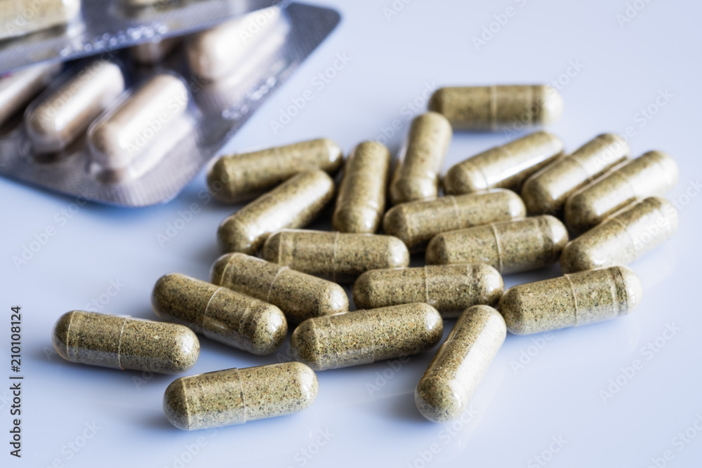 Biologically active food supplements in capsule on a light background, macro Biologically active food supplements in capsule on a light background, macro