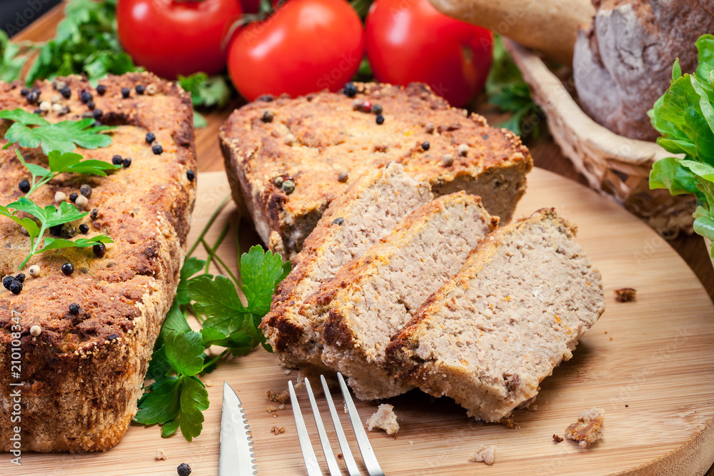 Traditional delicious meat pate with chicken liver on cutting board Traditional delicious meat pate with chicken liver on cutting board