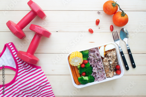 Creative flat lay of Nutrition lunch box, low calories and healthy ingredients. Sport and fitness concept with healthy food