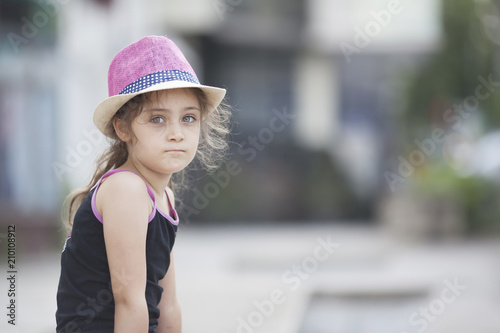 Summer portrait of a little girl in a straw hat photo