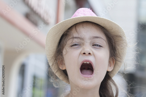 Summer portrait of a little girl in a straw hat photo