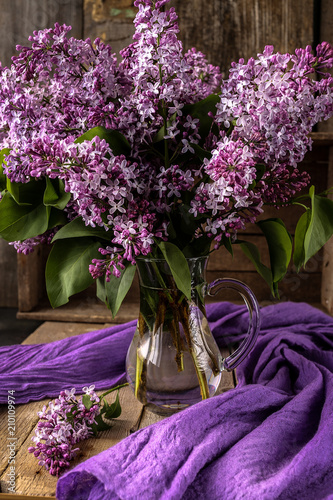 Beautiful composition with bouquet of lilac on old table