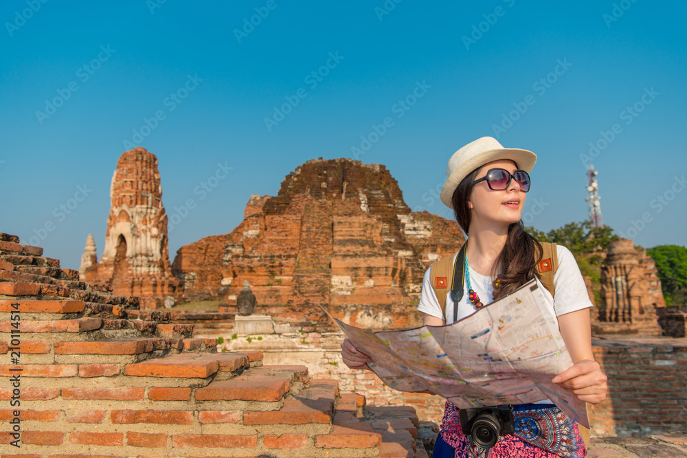 woman looking at the paper map to find her way