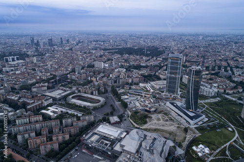 Aerial view of Milan  Italy  at dawn. On the right the new two skyscrapers of the CityLife district and the building site of the third tower.