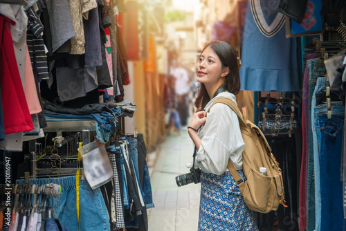 female tourist shopping in the street with camera