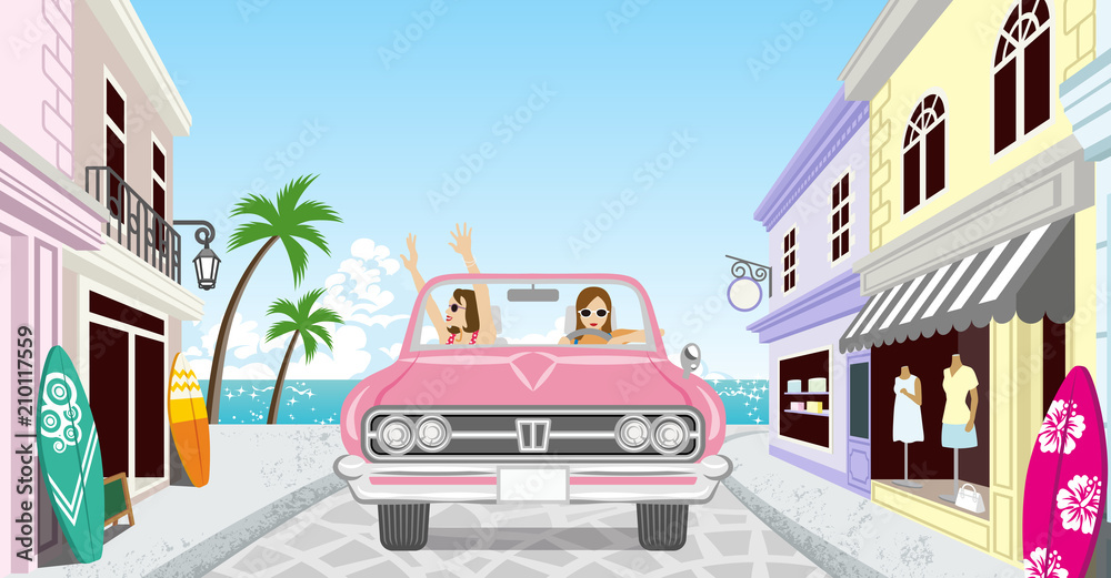 Two women driving a Pink convertible in summer nature - Old fashioned town