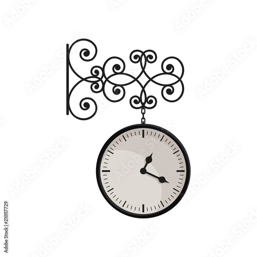 Hanging vintage clock with black metal frame and white dial. Street decor element. Mechanical device for measuring time