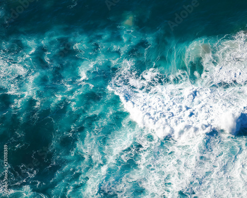 beautiful natural abstract background, turquoise water and waves are broken against a stone. Cabo da Roca, Portugal. The power of the ocean