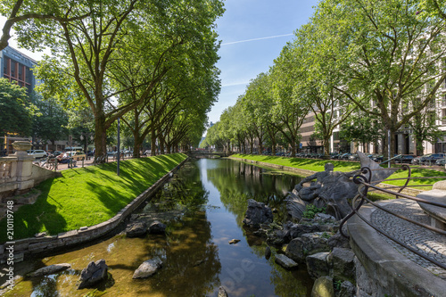 City river with trees and blue sky © rninov