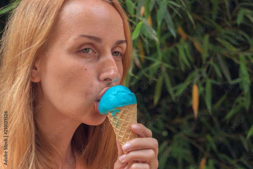 Young girl eating ice cream in summer hot weather. Young girl eating ice cream in summer hot weather.