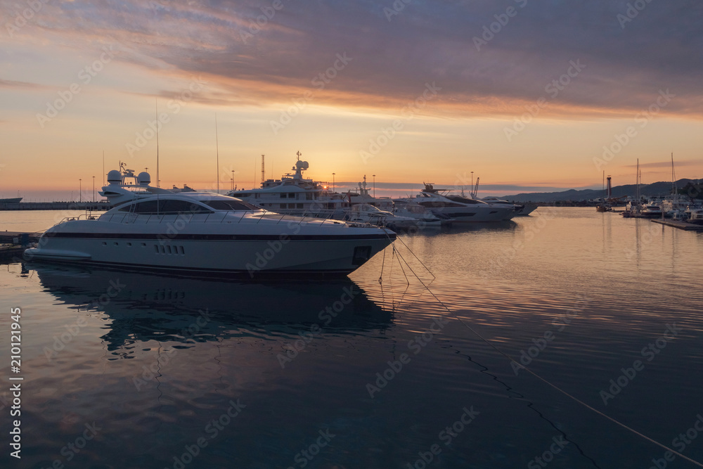 Luxury yachts docked in sea port at sunset, Sochi, Russia
