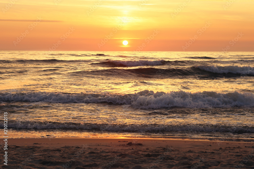 Sea waves at sunset. Baltic sea beach in Palanga.