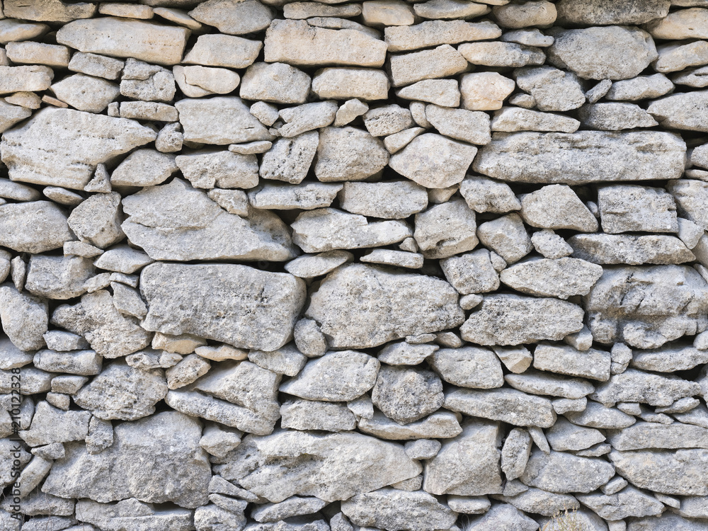 part of old dry stone wall built without cement or grout in southern france