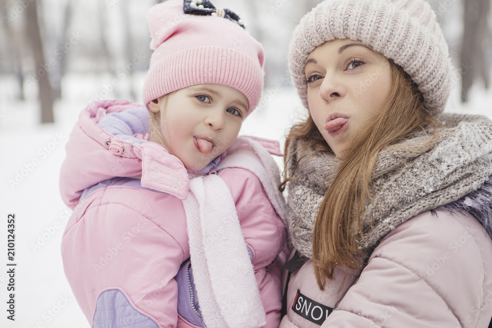 Happy loving caucasian family of mother father and daughter play, having fun in winter snowy park Happy loving caucasian family of mother father and daughter play, having fun in winter snowy park