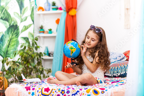 Little Girl with a globe in the arabic interior