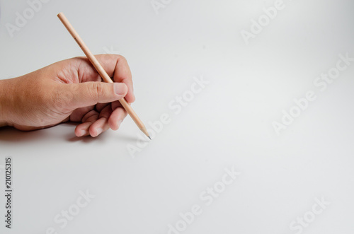 Left hand’s male with wooden pencil and copy space.