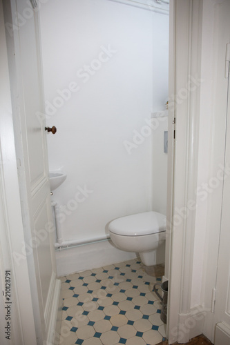 a small room under the stairs hides the toilet wc