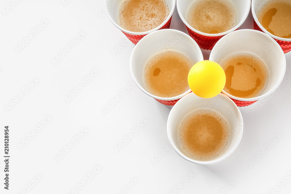 Fototapeta premium Cups and ball for beer pong on white background