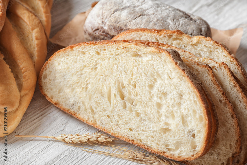 Pieces of fresh tasty bread on wooden table, closeup