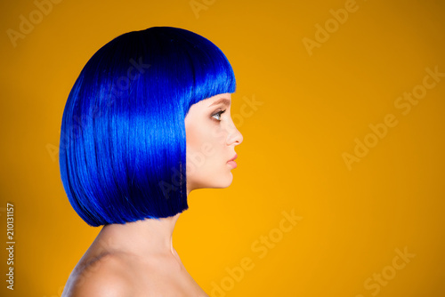 Profile portrait with copyspace empty place for product of pretty modern woman in bright blue wig isolated on yellow background