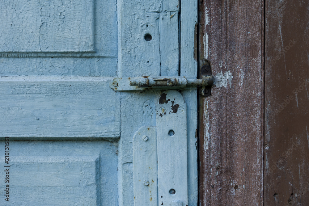 Fragment of blue wooden door. Vintage timber texture background. Rustic view.