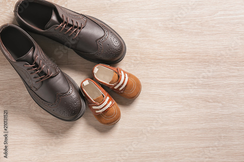 Big and small shoes on light background. Father's day