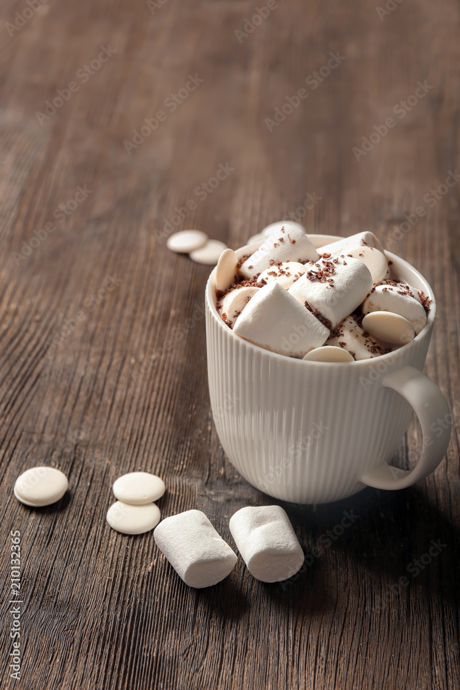 Cup of delicious hot cocoa with marshmallows on wooden background Cup of delicious hot cocoa with marshmallows on wooden background