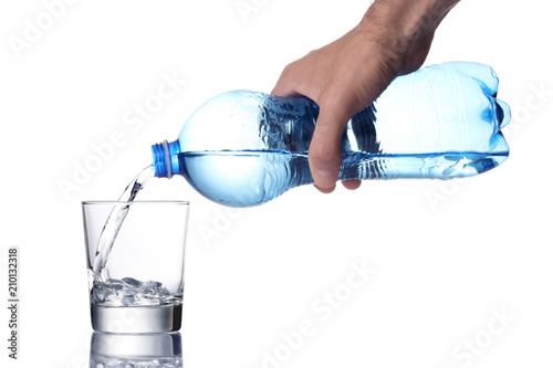 man's hand fill a water glass with a plastic bottle, clipping path included