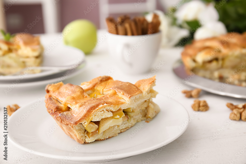 Plate with piece of delicious apple pie on wooden table Plate with piece of delicious apple pie on wooden table