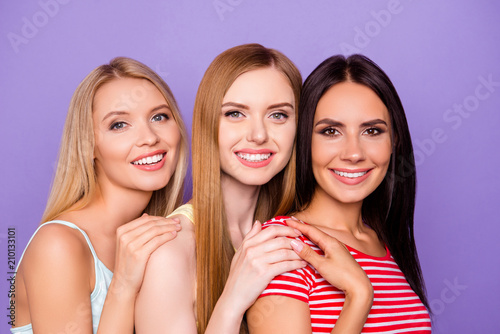 Head shot portrait of cute charming girls in casual outfits looking at camera isolated on vivid violet background. Society human authority people concept