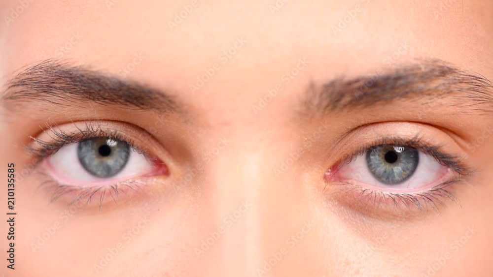 Beautiful female blue eyes closeup. Young woman eyes blinking and looking up. 4K UHD video 3840X2160 Beautiful female blue eyes closeup. Young woman eyes blinking and looking up. 4K UHD video 3840X2160