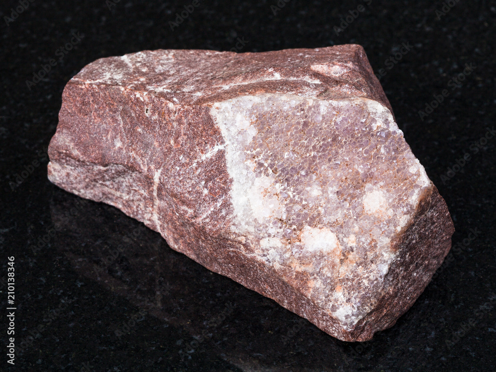 amethyst mineralization on rock on black