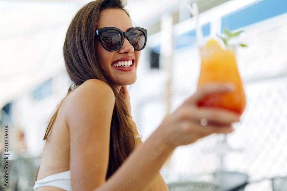 Attractive happy woman drinking cocktail Attractive happy woman drinking cocktail