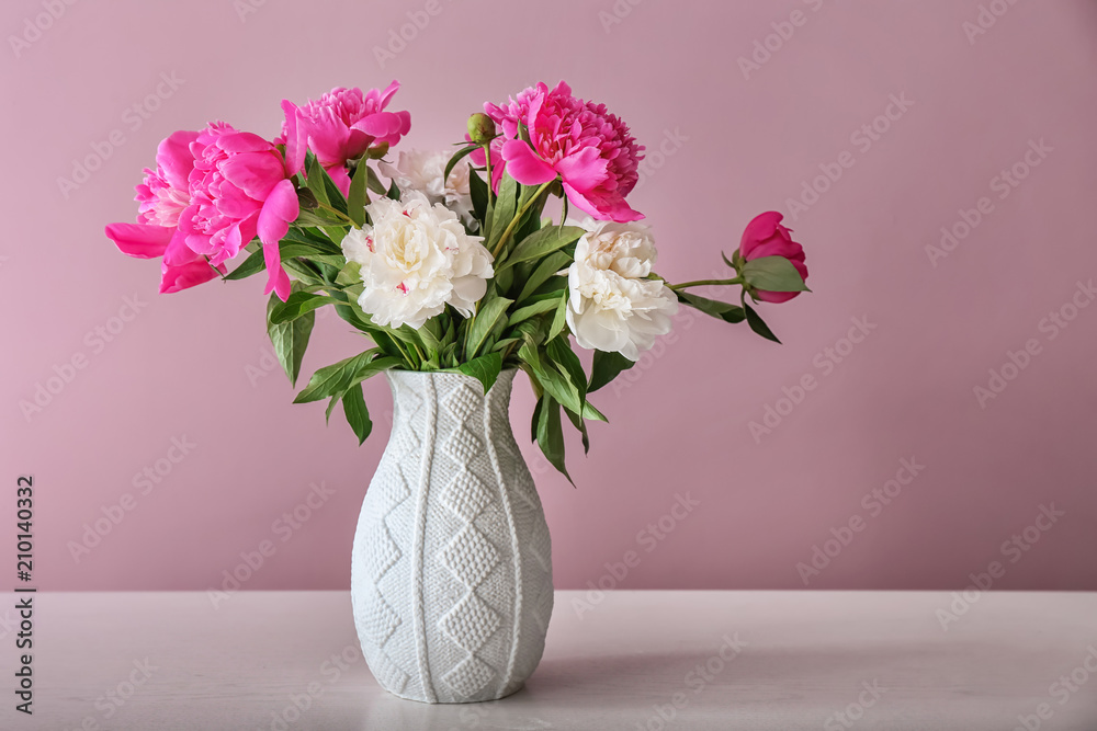 Vase with beautiful flowers on table