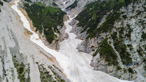 Aerial view of the mudflow with snow high in the Alpine mountains