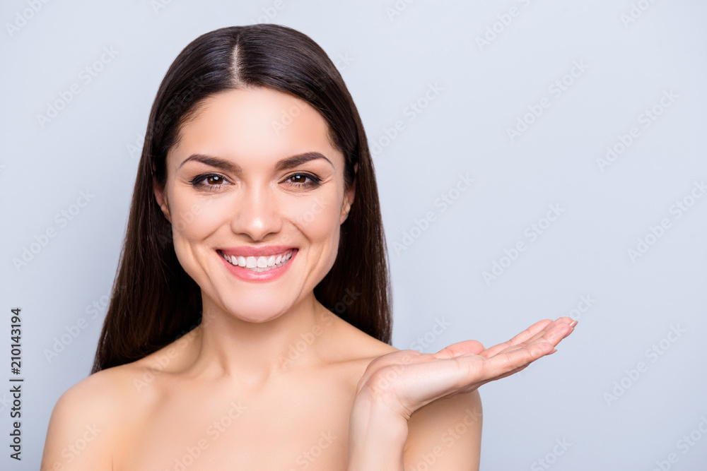 Advertisement choice advice recommend concept. Portrait of charming woman holding copyspace on palm isolated on grey background. Cream lotion vitamins detox scrub mask moisturizer concept Advertisement choice advice recommend concept. Portrait of charming woman holding copyspace on palm isolated on grey background. Cream lotion vitamins detox scrub mask moisturizer concept