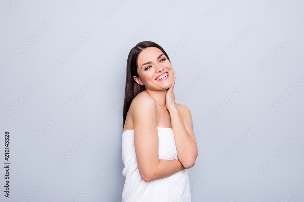 Cheerful funny positive toothy woman wrapped in white towel happy after procedure medical massage enjoying rest in spa center isolated on grey background wellness wellbeing concept Cheerful funny positive toothy woman wrapped in white towel happy after procedure medical massage enjoying rest in spa center isolated on grey background wellness wellbeing concept