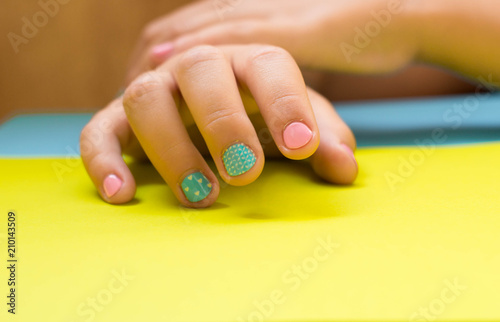 children's manicure in pastel colors on a pastel background