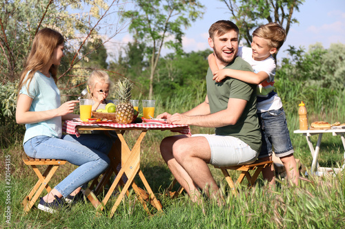 Happy family having lunch a...