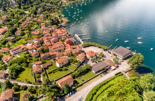 Aerial view of the village and the small harbor of Castelveccana, located on the shore of Lake Maggiore in the province of Varese, Lombardy, Italy photo