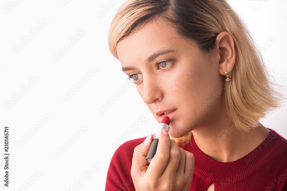 Beautiful young woman with lipstick. Applying make-up Beautiful young woman with lipstick. Applying make-up