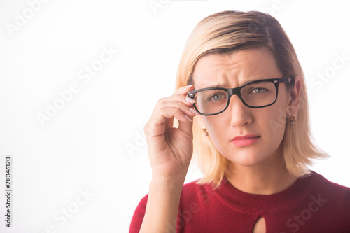 Woman wearing glasses with bad eyesight vision isolated on white