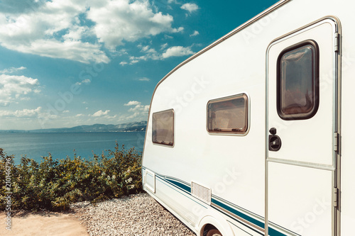 Fotografering Caravan Trailer Near Sea, Beach And Blue Sky
