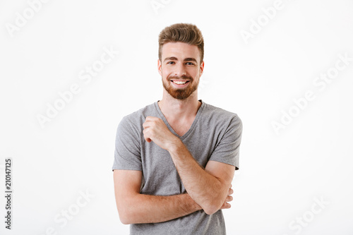 Handsome young man standing isolated smiling