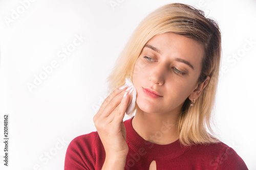 Woman Cleaning Face with white cotton pad. Beautiful Girl Removing Makeup White Cosmetic Cotton Pad. Face Skin Care. Isolated on white