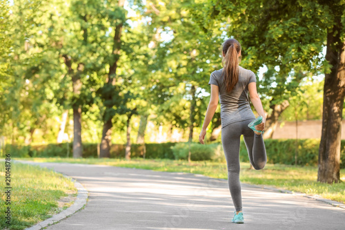 Sporty young woman training outdoors