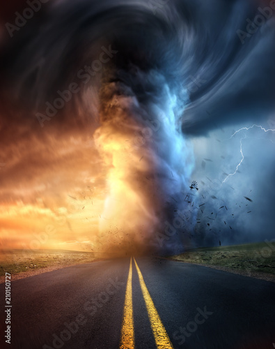 A powerful supercell storm at sunset producing a huge and destructive tornado touching down on a highway road. Mixed media illustration. photo