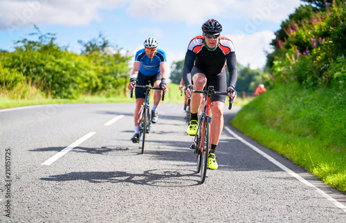 Obraz na płótnie Cyclists racing on country roads on a sunny day in the UK. w salonie