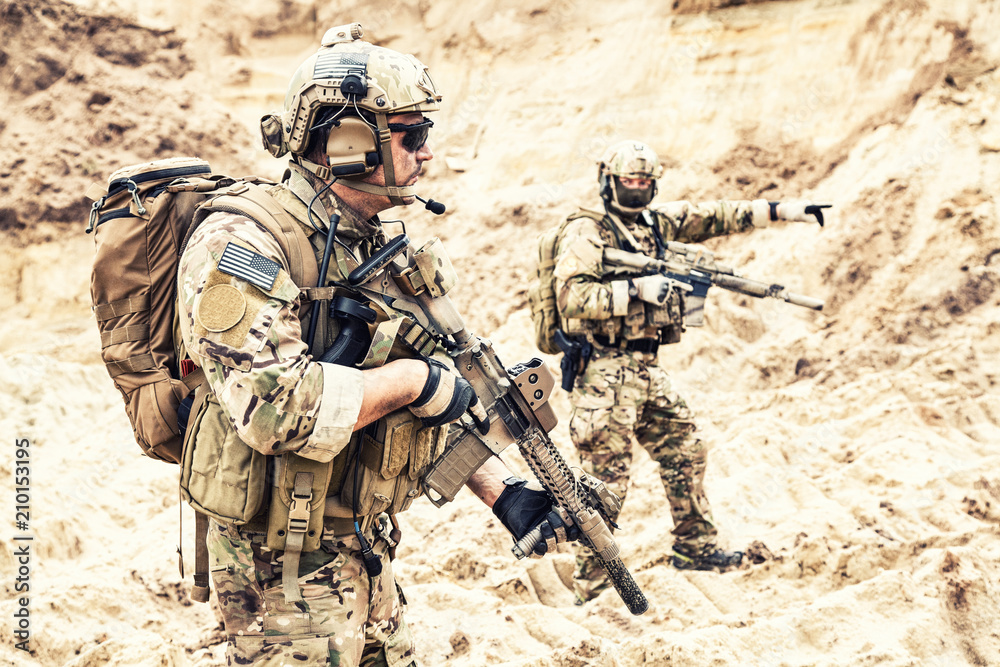 Two armed US army commandos or military scouts equipped with radio headset  moving forward in sands during enemy area reconnaissance. Special forces  operation, long range surveillance mission in desert Stock-foto | Adobe