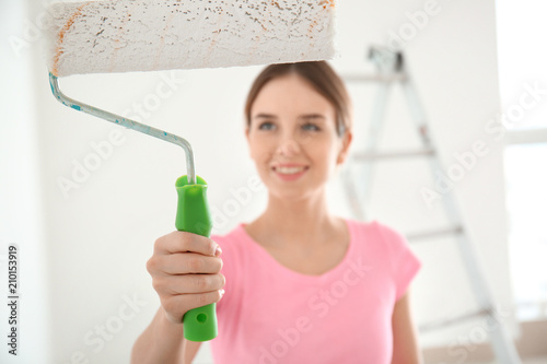Female painter using roller...
